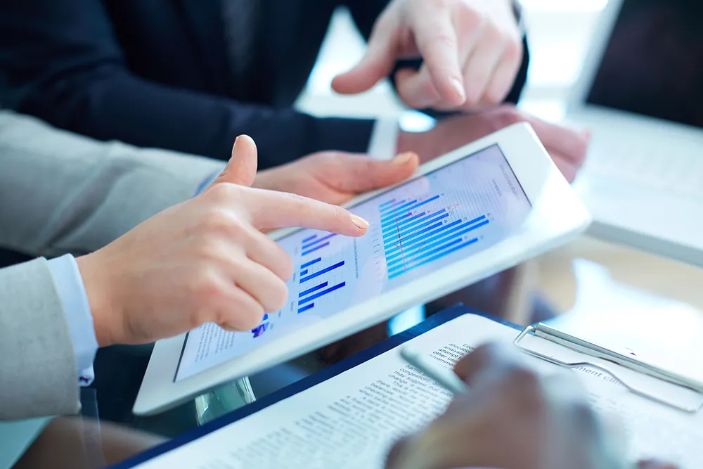 discussion of business document in touchscreen at meeting
